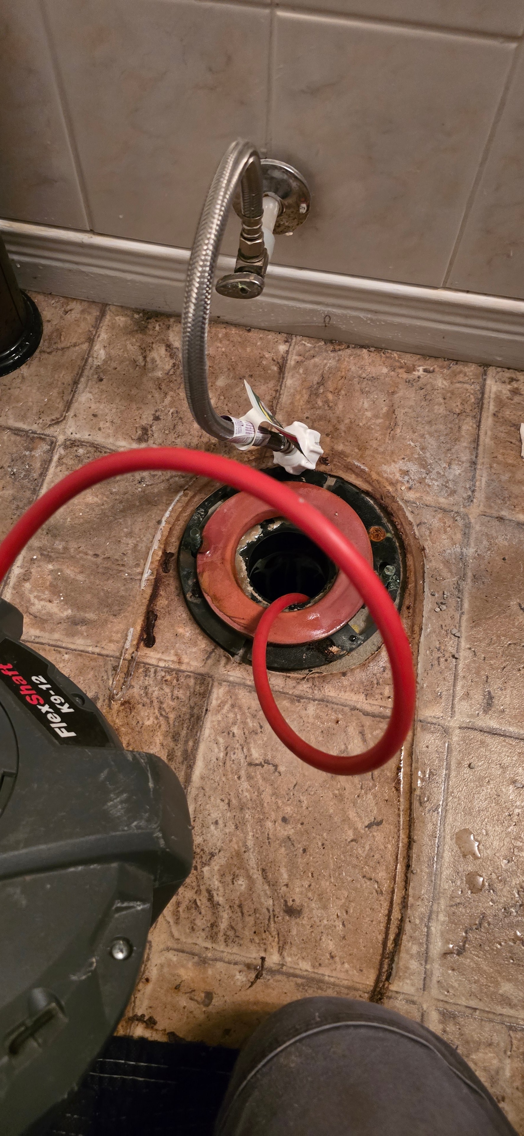 Drain cleaning and plumbing service technician at work