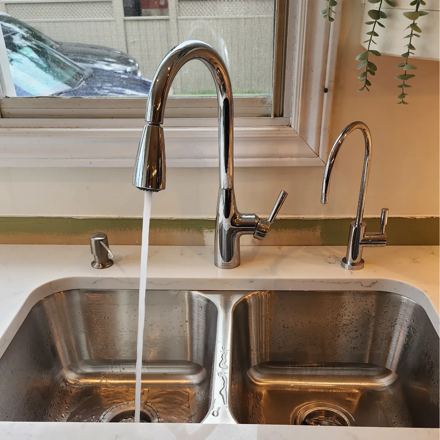 Chrome kitchen faucet running water