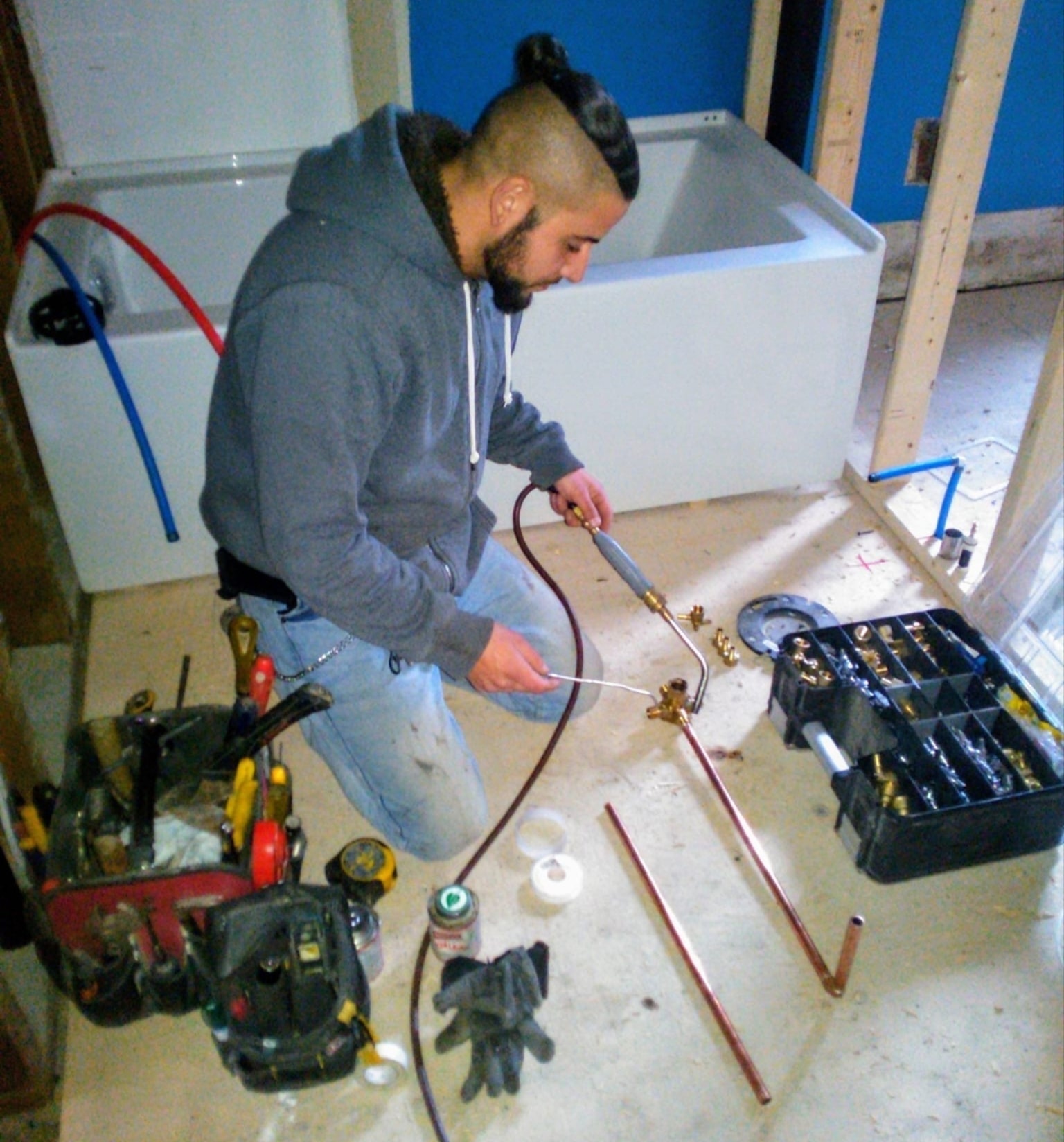 Plumber soldering copper pipes