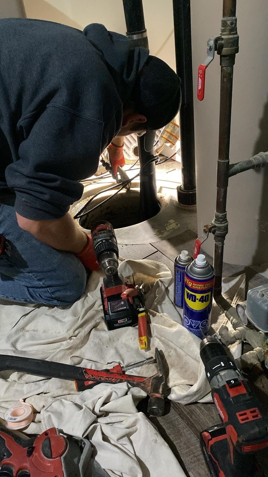 Plumber working under sink