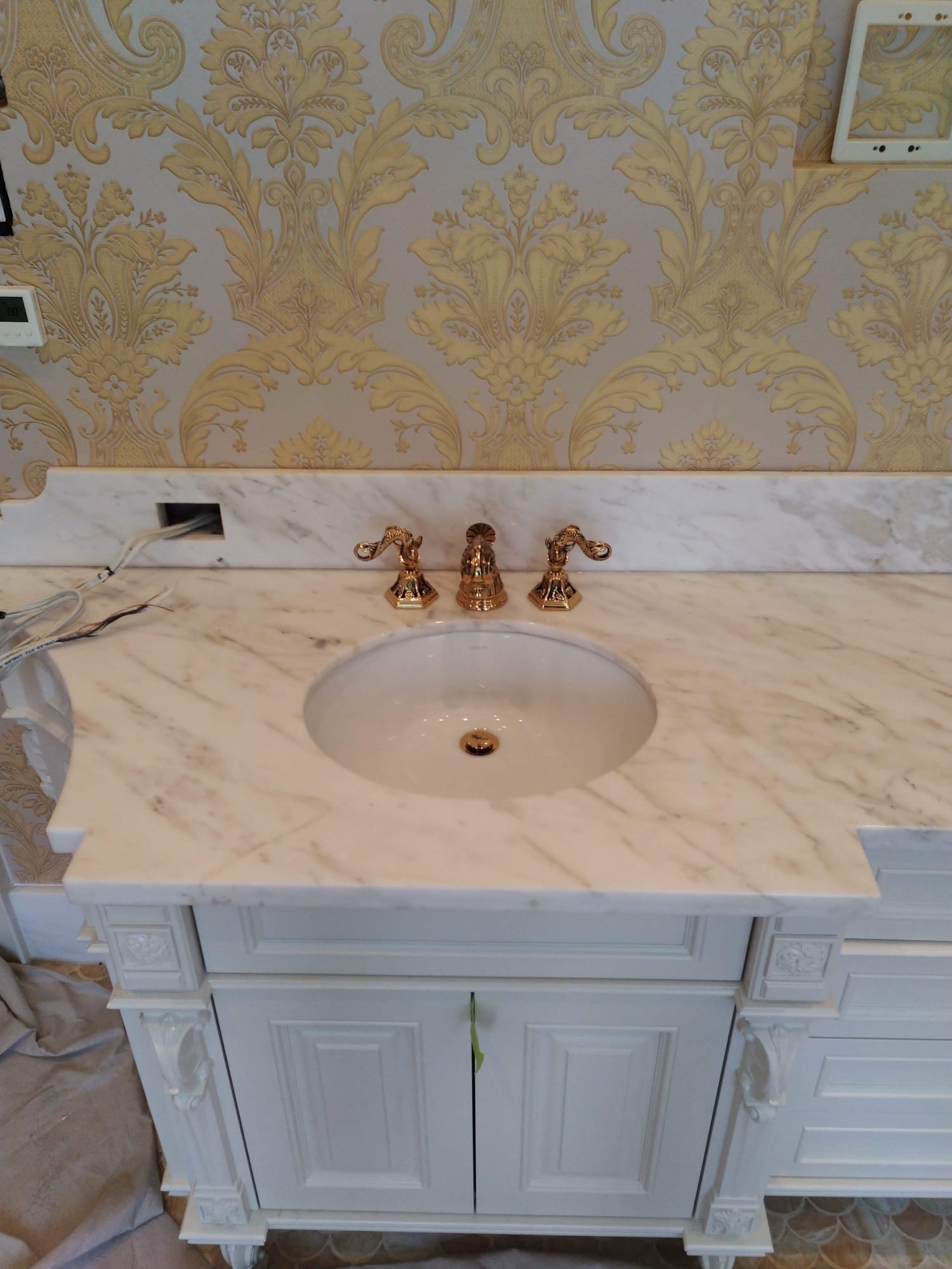 Luxury marble vanity with gold faucet installation